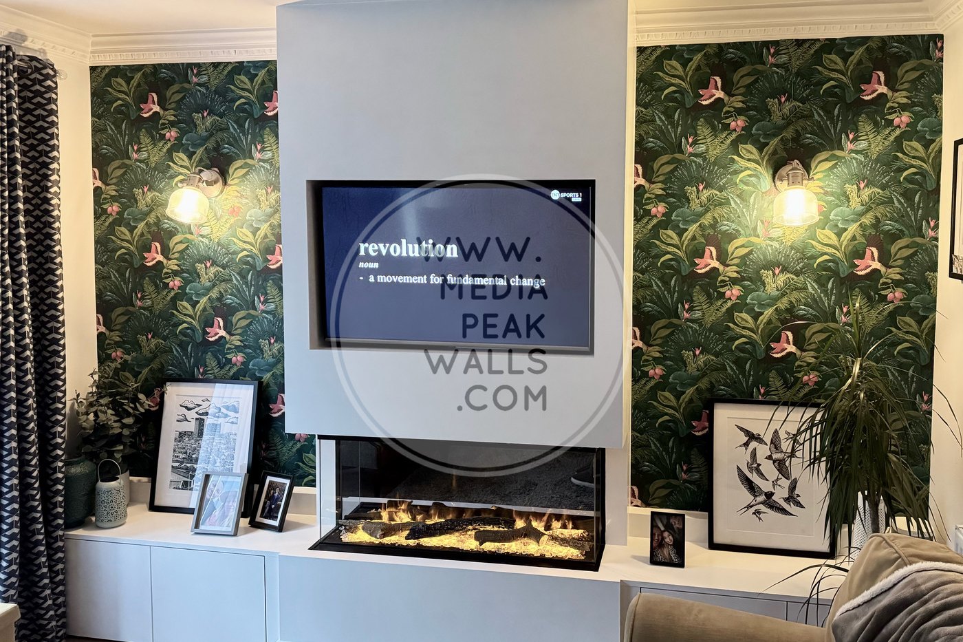 Bespoke media wall with wide inset fire and fitted base units by Peak Media Walls